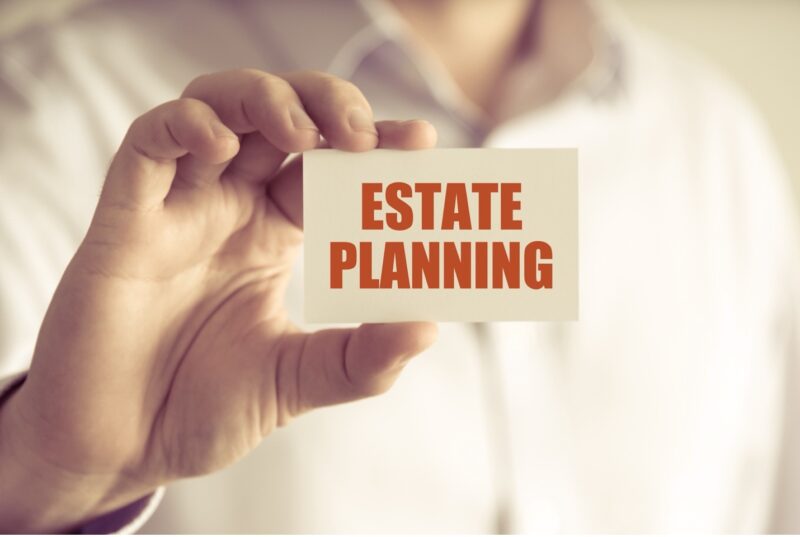 Estate Planning 101 Close up of hand holding an estate planning sign