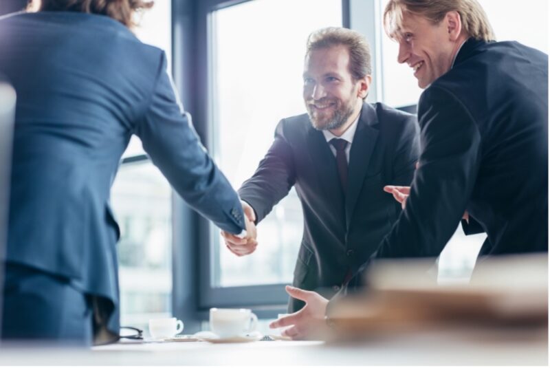 Businessmen smiling and shaking hands
