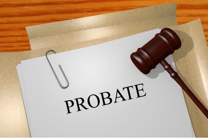 A stack of documents with a title page that reads Probate and a gavel