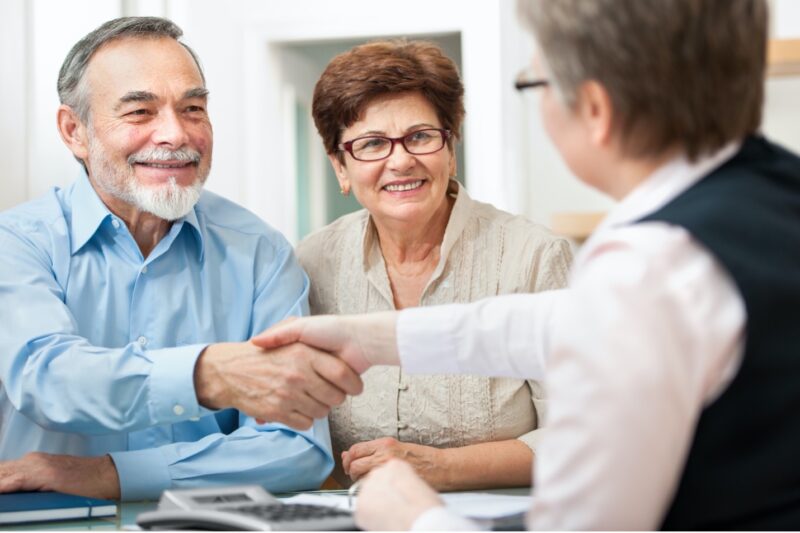 A senior couple conferring with an estate planning professional.