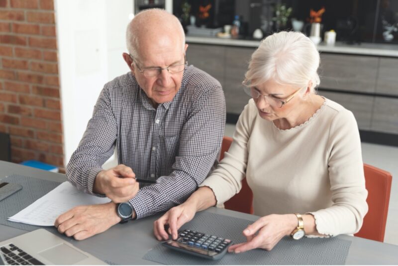 A senior couple calculating finances together.