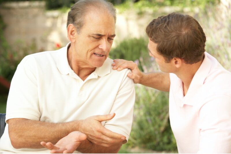 A senior man and his son discussing advance health care directives