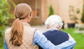 Younger woman with arm around older woman. Navigating Elder Care Conflicts: How Family Mediators Can Help